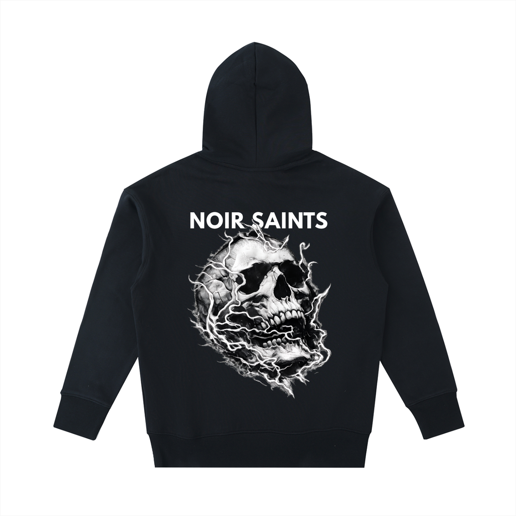 A black pullover hoodie shown from the back, featuring a large white graphic of a skull with lightning effects and the text 'NOIR SAINTS' printed above it, set against a plain white background.