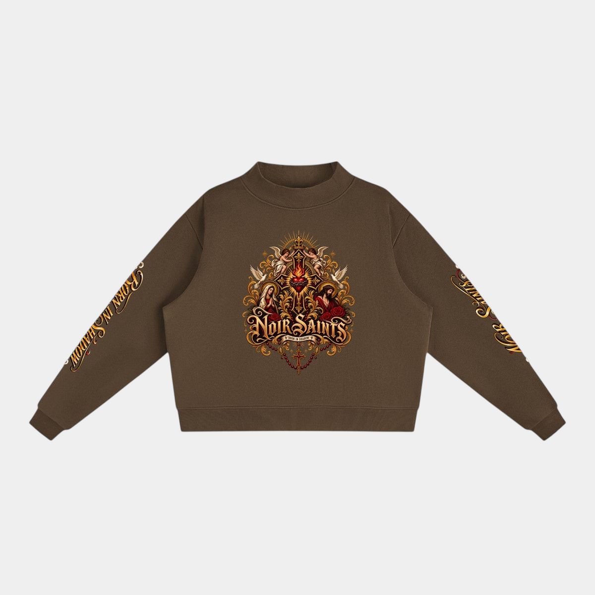 NOIR SAINTS Canada brown cropped fleece mock-neck sweatshirt with ornate sacred heart graphic and sleeve lettering.