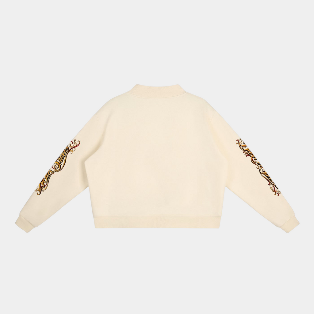 Back view of NOIR SAINTS Canada cream cropped fleece mock-neck sweatshirt with ornate graphic sleeve detailing.